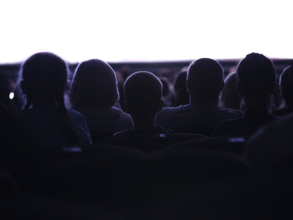 people at the cinema watching television