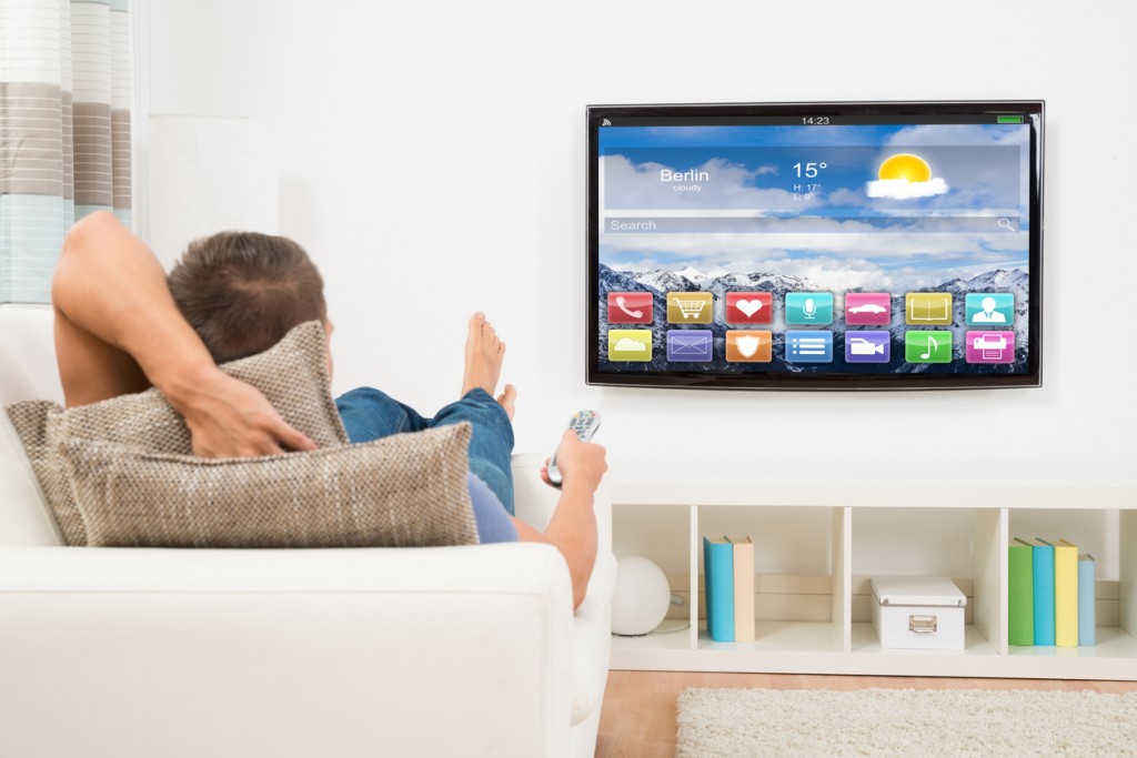 Man Using Remote Control In Front Of Television