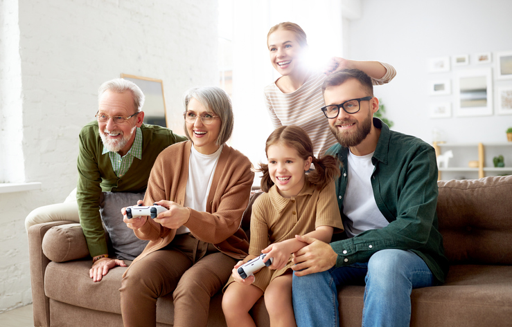 Big family playing video games together, enjoying weekend TV