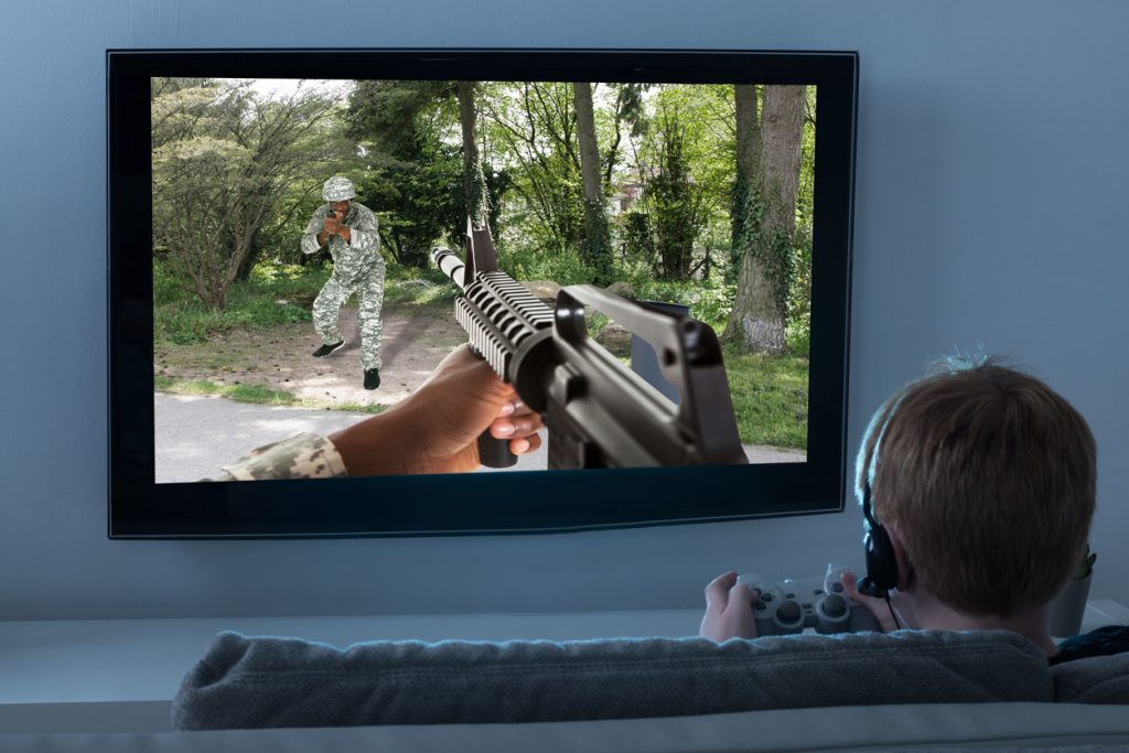Boy playing a FPS game on an 8K Smart TV