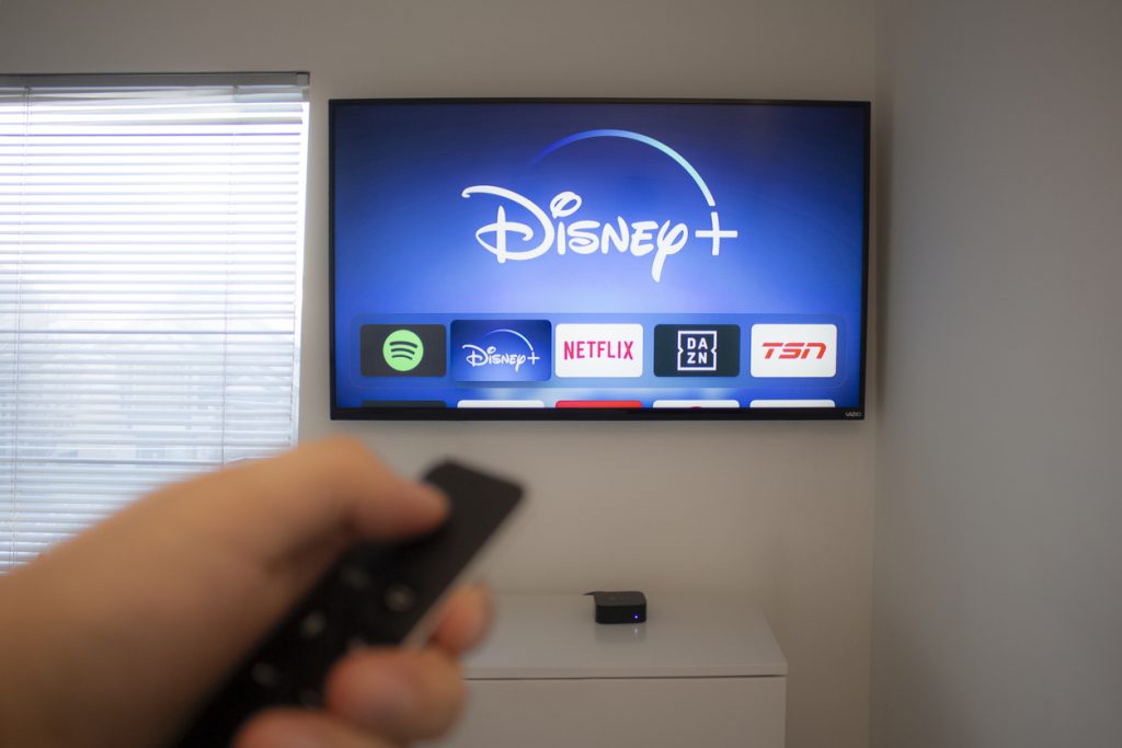 Someone streaming popular streaming service Disney + on their smart TV