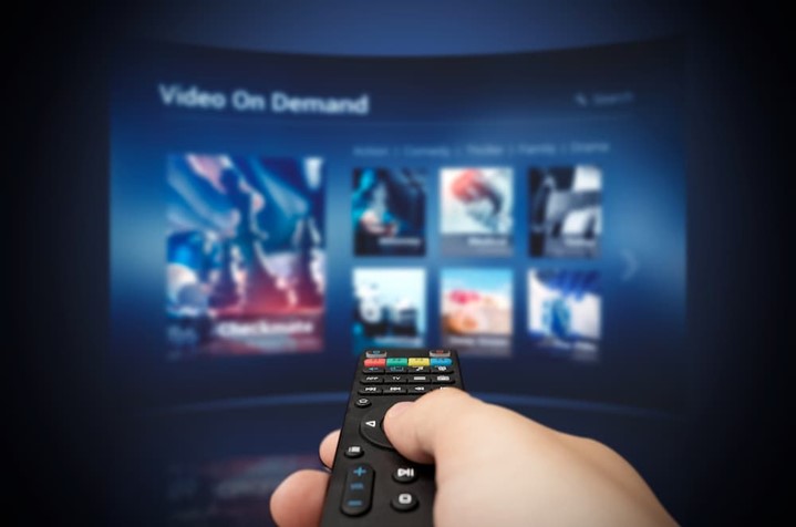 Someone pointing a remote at a smart TV
