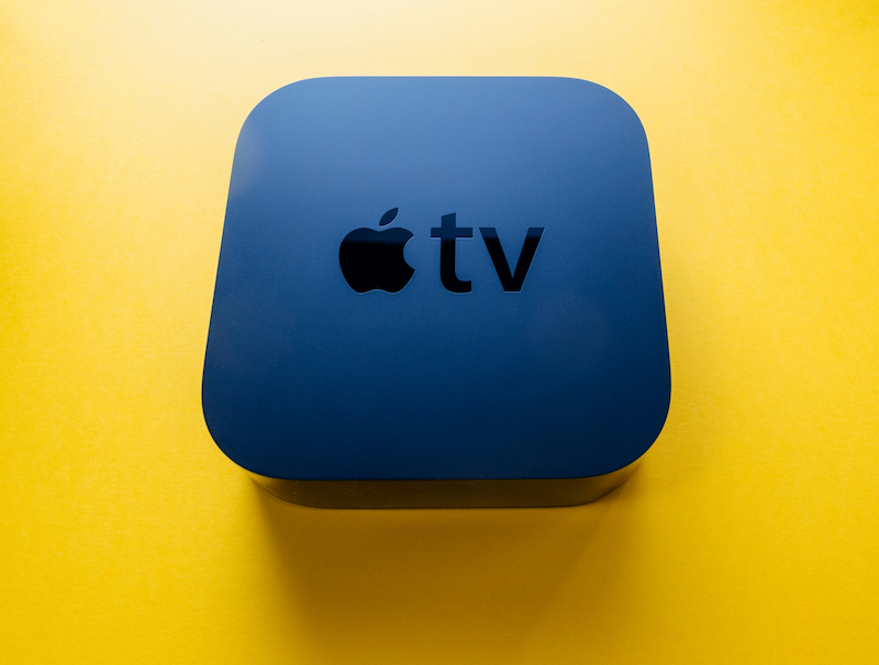 Apple TV box on yellow background